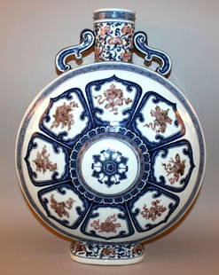 A GOOD LARGE CHINESE UNDERGLAZE-BLUE & COPPER-RED: A GOOD LARGE CHINESE UNDERGLAZE-BLUE & COPPER-RED PORCELAIN MOON FLASK, each side decorated with panels of the Eight Buddhist Emblems radiating from a central raised circular boss, the edges with scro