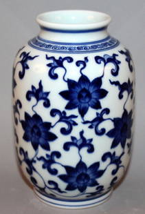 A CHINESE BLUE & WHITE PORCELAIN VASE, the sides: A CHINESE BLUE & WHITE PORCELAIN VASE, the sides decorated with an overall design of scroll-stemmed lotus, the base with a six-character Yongzheng mark, 5.9in high.