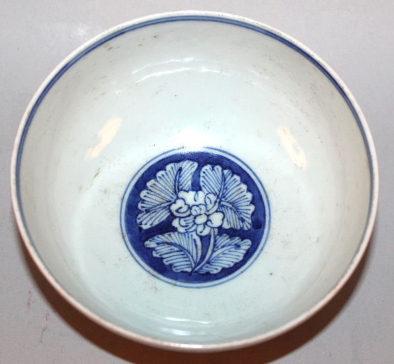 A CHINESE BLUE & WHITE PORCELAIN BOWL, the sides: A CHINESE BLUE & WHITE PORCELAIN BOWL, the sides decorated with two dragons and scrolling foliage, the base with a six-character Wanli mark, 5.4in diameter & 2.6in high.