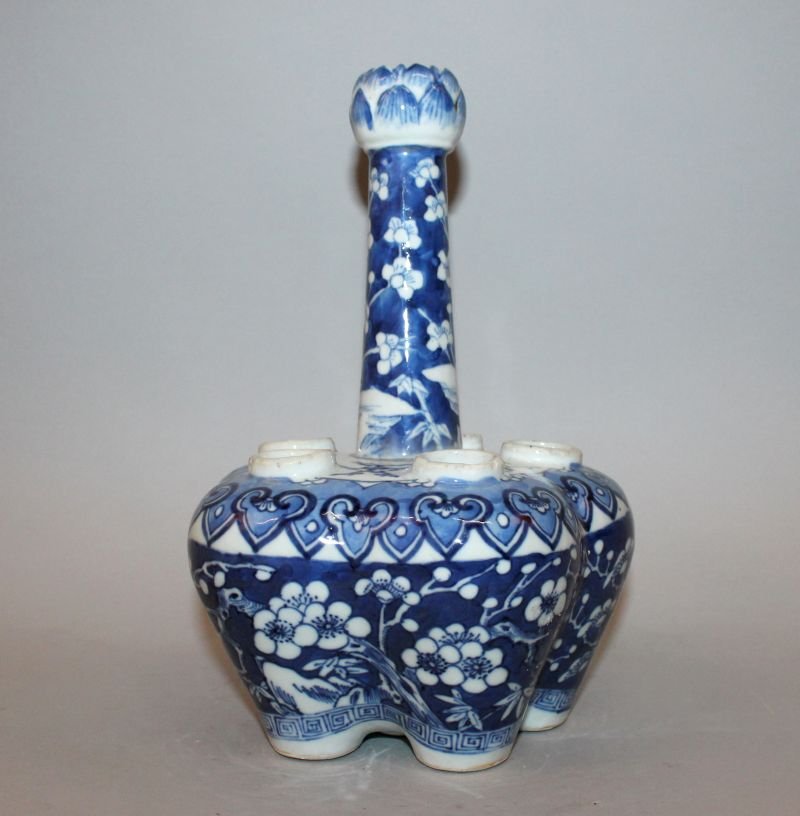 A 19TH CENTURY CHINESE BLUE & WHITE PORCELAIN CROCUS OR: A 19TH CENTURY CHINESE BLUE & WHITE PORCELAIN CROCUS OR TULIP VASE, the sides painted with prunus blossom reserved in white against a blue-wash crackled-ice ground, 9.8in high.