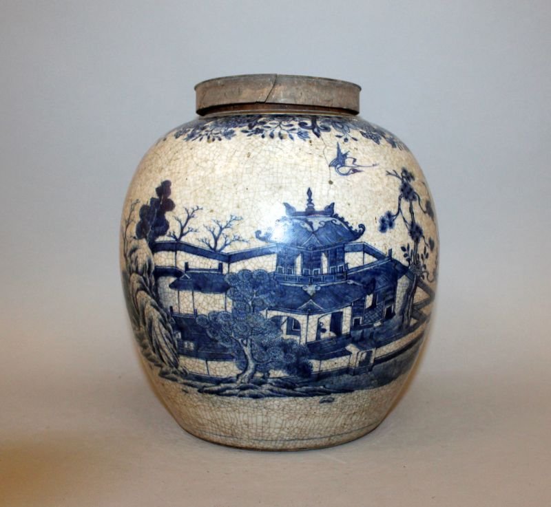 AN UNUSUAL 18TH/19TH CENTURY CHINESE BLUE & WHITE: AN UNUSUAL 18TH/19TH CENTURY CHINESE BLUE & WHITE CRACKLEGLAZE PORCELAIN JAR, together with a replacement wood cover, the sides painted with a continuous river landscape scene, the jar itself 9.4in hi