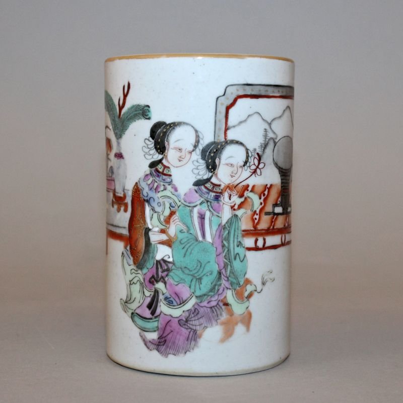 A CHINESE FAMILLE ROSE PORCELAIN BRUSHPOT, the: A CHINESE FAMILLE ROSE PORCELAIN BRUSHPOT, the cylindrical body decorated with two ladies seated before a low table and screen, the base with a Tongzhi seal mark, 2.9in diameter at base & 4.7in high.