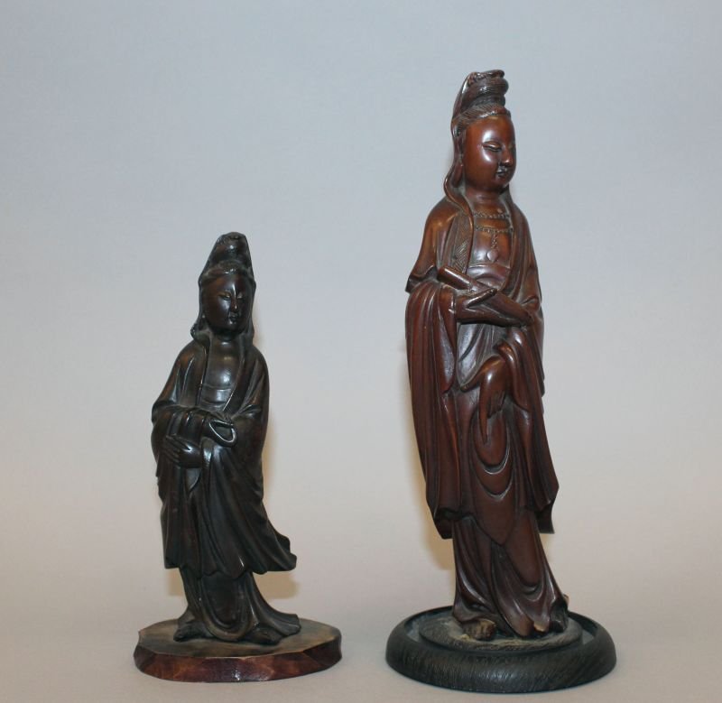 A GOOD QUALITY 19TH CENTURY CHINESE HARDWOOD CARVING OF: A GOOD QUALITY 19TH CENTURY CHINESE HARDWOOD CARVING OF GUANYIN, mounted on a fixed wood stand, her slightly curved body clad in flowing robes, the Goddess holding a scroll in one hand, 9in high overa