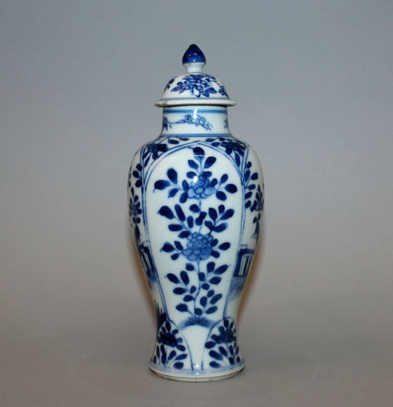 A CHINESE KANGXI PERIOD BLUE & WHITE PORCELAIN VASE &: A CHINESE KANGXI PERIOD BLUE & WHITE PORCELAIN VASE & COVER, circa 1700, the sides of the baluster form body painted with panels of a lady and boy alternating with panels of extended foliage, 6.9in hi