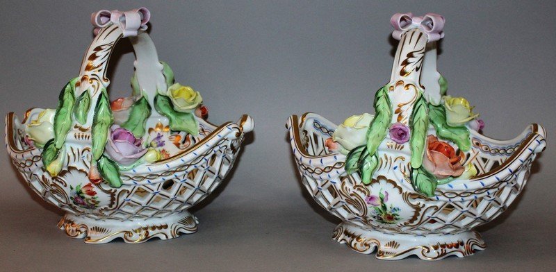 A GOOD PAIR OF HERAND HAND PAINTED PIERCED BASKETS: A GOOD PAIR OF HERAND HAND PAINTED PIERCED BASKETS painted with flowers and encrusted with roses. 10ins wide.