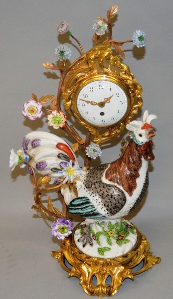 A SUPERB 18TH CENTURY DESIGN PORCELAIN AND ORMOLU CLOCK: A SUPERB 18TH CENTURY DESIGN PORCELAIN AND ORMOLU CLOCK in the Manner of J. J. Kindler, with eight day movement and porcelain cockerel and flower heads. 16ins high.