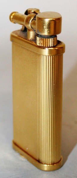 AN OLD DUNHILL GOLD COLOURED GAS LIGHTER, No. 357331.: AN OLD DUNHILL GOLD COLOURED GAS LIGHTER, No. 357331.