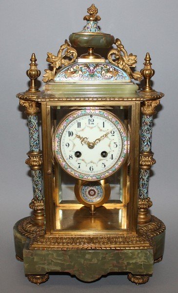 A GOOD 19TH CENTURY FRENCH CHAMPLEVE ENAMEL, ORMOLU AND: A GOOD 19TH CENTURY FRENCH CHAMPLEVE ENAMEL, ORMOLU AND GREEN ONYX CLOCK with eight day movement, striking on a gong, dial painted with garlands with urn finial and column supports. 17ins high.