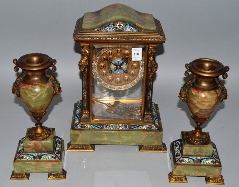 A GOOD 19TH CENTURY FRENCH CHAMPLEVE ENAMEL, ORMOLU AND: A GOOD 19TH CENTURY FRENCH CHAMPLEVE ENAMEL, ORMOLU AND GREEN ONYX THREE PIECE CLOCK GARNITURE with serpentine top, eight day movement, striking on a gong, canted sides with caryatid figures. 13.5ins