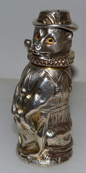 A VICTORIAN NOVELTY SILVER MODEL OF A PERFORMING DOG: A VICTORIAN NOVELTY SILVER MODEL OF A PERFORMING DOG PEPPERETTE, wearing a hat and neck ruff, pipe in his mouth. 3.75ins high. London 1869 Maker: Charles Stuart Harris.