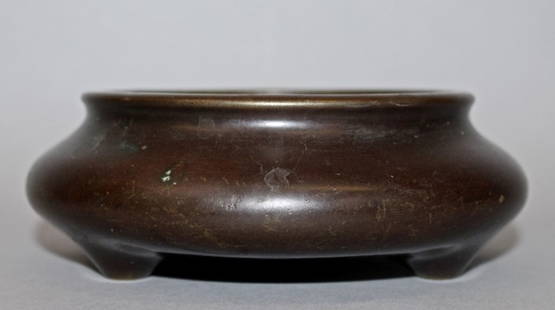 A GOOD CHINESE BRONZE TRIPOD CENSER, weighing 1.7Kg,: A GOOD CHINESE BRONZE TRIPOD CENSER, weighing 1.7Kg, probably 16th/17th Century, of shallow form and with good unpolished patination, the base with an unusual nine-character seal mark, 6.25in wide at