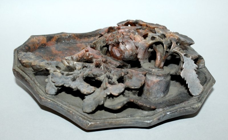 A 20TH CENTURY CHINESE SOAPSTONE DISH, the interior: A 20TH CENTURY CHINESE SOAPSTONE DISH, the interior carved in high pierced relief with extended leafage and a flowerhead sprouting from a vase, 8.75in wide.