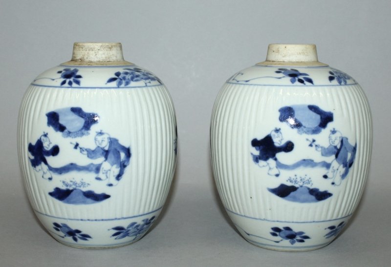A PAIR OF CHINESE BLUE & WHITE PORCELAIN RIBBED JARS,: A PAIR OF CHINESE BLUE & WHITE PORCELAIN RIBBED JARS, each decorated with medallion panels of playing boys, each short neck unglazed, 6.1in high. £200-300