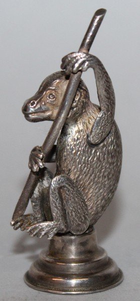 AN EDWARDIAN SILVER NOVELTY TABLE SEAL as a monkey: AN EDWARDIAN SILVER NOVELTY TABLE SEAL as a monkey holding a staff on a plain unengraved base. Birmingham 1907. Maker: Crisford & Norris. 2.25ins.