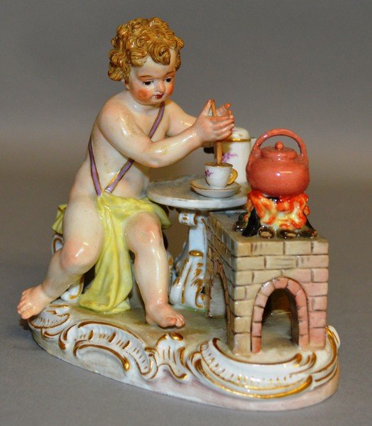 A GOOD SMALL MEISSEN GROUP OF A CUPID sitting beside a: A GOOD SMALL MEISSEN GROUP OF A CUPID sitting beside a stove with fire and kettle, he stirring a cup and saucer. 4.25ins long. Cross swords mark in blue. Incised No. C177.
