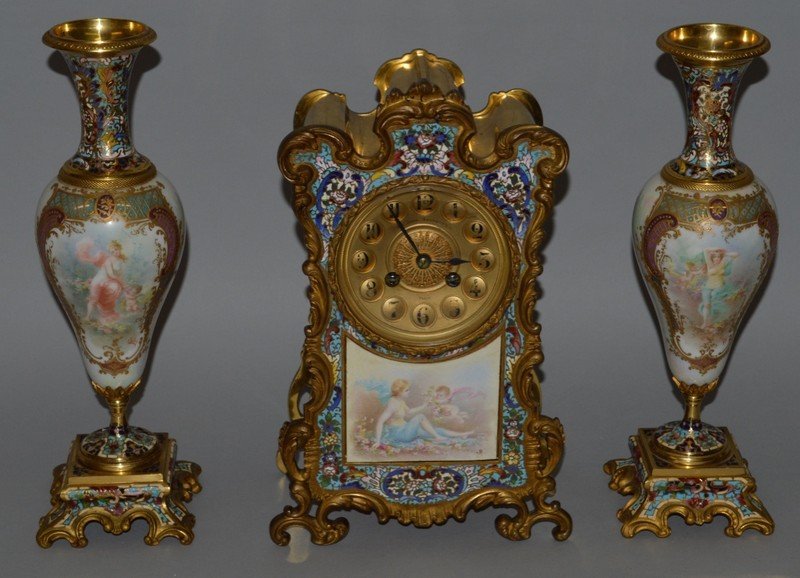 A SUPERB 19TH CENTURY FRENCH BRONZE CHAMPLEVE ENAMEL: A SUPERB 19TH CENTURY FRENCH BRONZE CHAMPLEVE ENAMEL AND PORCELAIN THREE PIECE CLOCK GARNITURE, SIR JOHN BENNETT LTD, PARIS, circular gilt dial with eight day movement, strike action, the clock case w