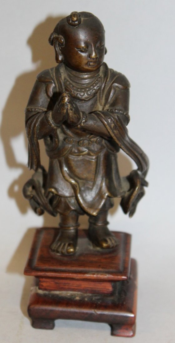A 17TH CENTURY CHINESE BRONZE FIGURE OF A BOY ACOLYTE, (1 of 6)
