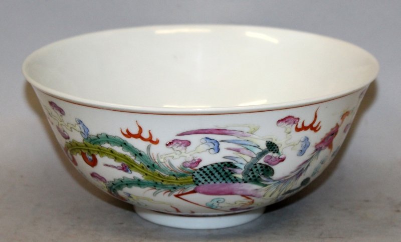 A CHINESE GUANGXU MARK & PERIOD FAMILLE ROSE PORCELAIN: A CHINESE GUANGXU MARK & PERIOD FAMILLE ROSE PORCELAIN DRAGON & PHOENIX BOWL, the sides painted with a confronting dragon and a phoenix disputing a flaming pearl amidst flame and cloud scrolls and abo
