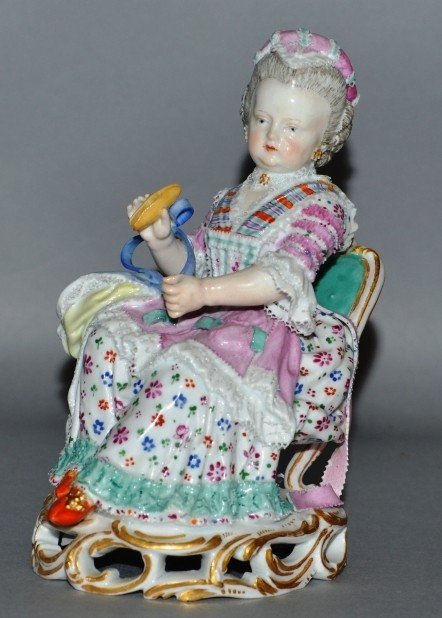 A GOOD EARLY 19TH CENTURY MEISSEN FIGURE OF A YOUNG: A GOOD EARLY 19TH CENTURY MEISSEN FIGURE OF A YOUNG LADY SEWING WITH A SHUTTLE seated on a gilt chair. Cross swords mark in blue. Incised No. C28.5.5ins high. £200-300