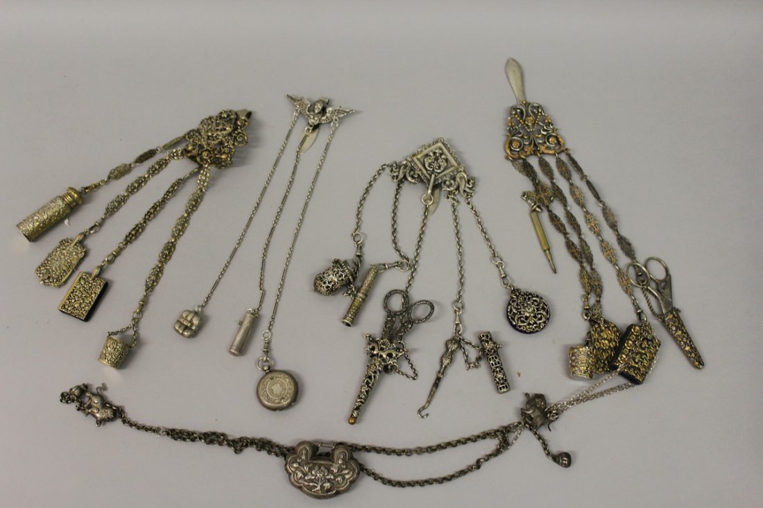 A COLLECTION OF FOUR CHÂTELAINES with bottles, books,: A COLLECTION OF FOUR CHÂTELAINES with bottles, books, notepads etc. £600-800