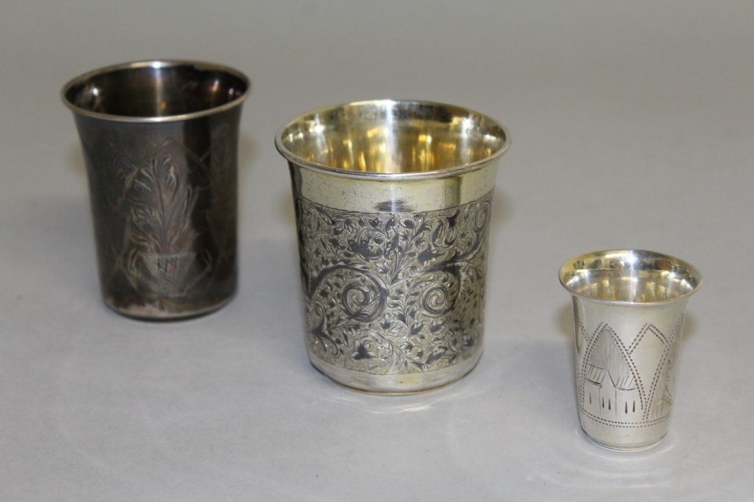 A RUSSIAN SILVER NIELLO BEAKER, 6.5cms diameter, 7cms: A RUSSIAN SILVER NIELLO BEAKER, 6.5cms diameter, 7cms high, stamped 84, dated 1847, and TWO OTHER BEAKERS, 7cms and 4.5cms high (3). £100-200