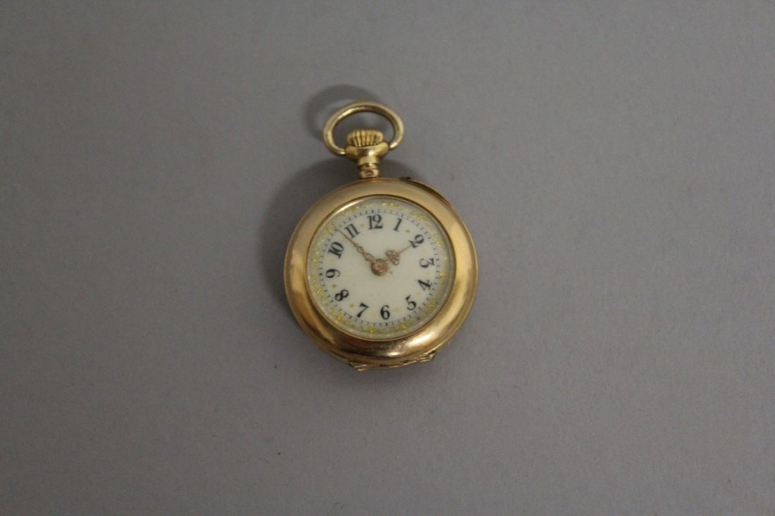 A SMALL DIAMOND SET 18ct GOLD FOB WATCH. £80-150: A SMALL DIAMOND SET 18ct GOLD FOB WATCH. £80-150