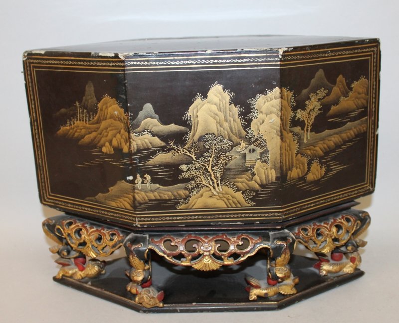 AN UNUSUAL & ELABORATE EARLY 20TH CENTURY CHINESE GILT: AN UNUSUAL & ELABORATE EARLY 20TH CENTURY CHINESE GILT WOOD STAND, of lozenge section with a lacquered wood cover decorated with figural and river landscape scenes, the galleried stand with pierced an