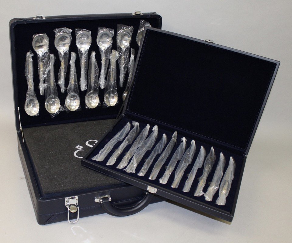 A SET OF CUTLERY, in a fitted case together with a: A SET OF CUTLERY, in a fitted case together with a similar set of steak knives.