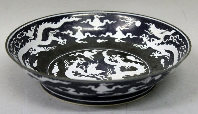 A CHINESE PORCELAIN DRAGON DISH, decorated in white on (1 of 3)