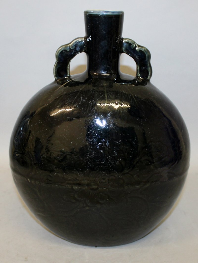 A CHINESE BLACK GLAZED PORCELAIN MOON FLASK, the sides (1 of 6)