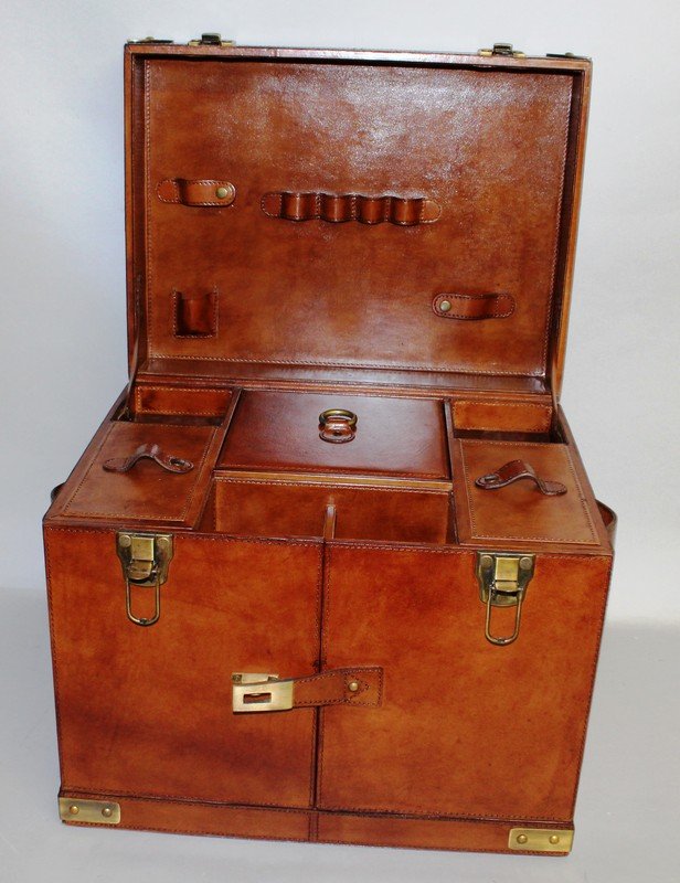 A GOOD BRASS BOUND LEATHER PICNIC HAMPER with lifting: A GOOD BRASS BOUND LEATHER PICNIC HAMPER with lifting lid and two folding doors enclosing fitted interior.1ft 6ins wide x 1ft 2ins deep x 1ft 2ins high.