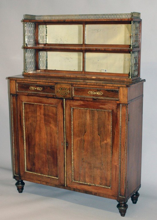 A SUPERB REGENCY ROSEWOOD CHIFFONIER, Attributed to: A SUPERB REGENCY ROSEWOOD CHIFFONIER, Attributed to JOHN MCLEAN, the top with mirrored back, brass column supports and brass grilled sides, two shelves, the base with two small drawers over double pan