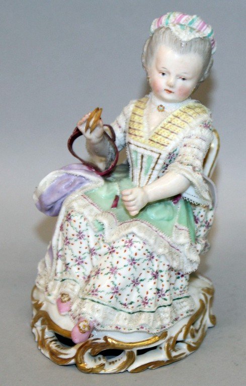 A 19TH CENTURY MEISSEN FIGURE OF A WOMAN, lace: A 19TH CENTURY MEISSEN FIGURE OF A WOMAN, lace encrusted dress, sitting in a chair. 5ins high. Cross swords mark in blue.
