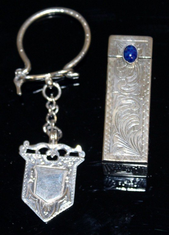 A SILVER LIPSTICK HOLDER and a SILVER KEY RING.: A SILVER LIPSTICK HOLDER and a SILVER KEY RING.