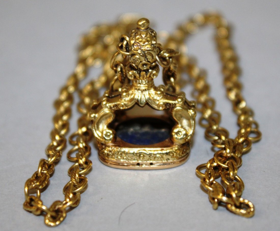 A GOOD GOLD PENDANT FOB SEAL ON A CHAIN with rounded: A GOOD GOLD PENDANT FOB SEAL ON A CHAIN with rounded rectangular lapis lazuli intaglio incised with conjoined initials T.S. or S.T. with EARLS CORONET.