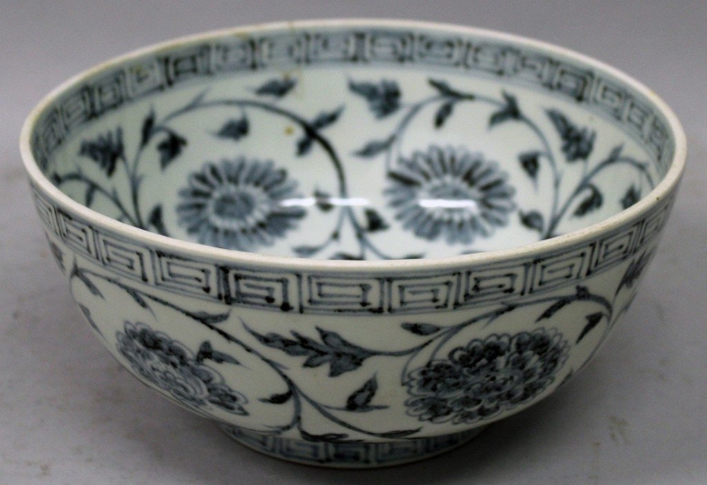 A CHINESE MING STYLE BLUE & WHITE PORCELAIN BOWL,: A CHINESE MING STYLE BLUE & WHITE PORCELAIN BOWL, decorated with formal scrolling foliage, 8.3in diameter & 3.8in high.