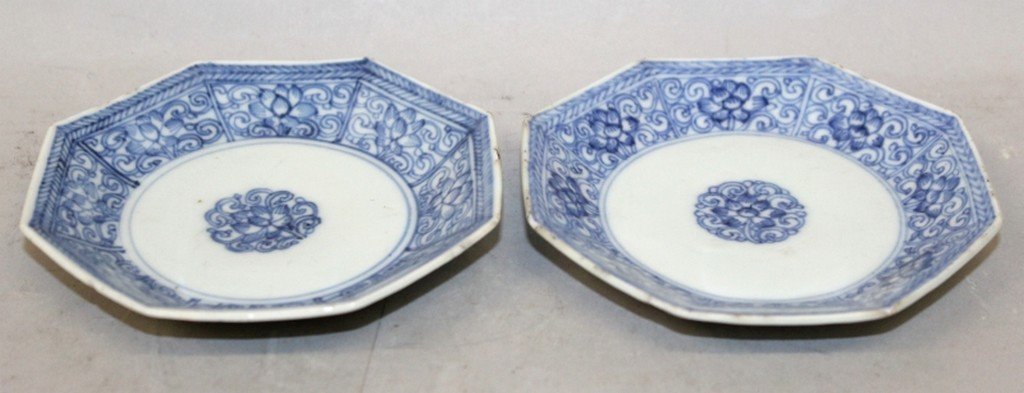 A PAIR OF EARLY 18TH CENTURY CHINESE KANGXI/YONGZHENG: A PAIR OF EARLY 18TH CENTURY CHINESE KANGXI/YONGZHENG PERIOD BLUE & WHITE PORCELAIN OCTAGONAL SAUCERS, each painted with repeated panels of formal scroll-stemmed lotus, 4.1in wide.