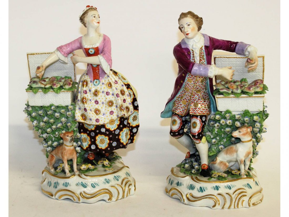 A very good pair of "Chelsea-Derby" porcelain figures: A very good pair of "Chelsea-Derby" porcelain figures of a gallant and young girl selling fruit, encrusted with flowers, a dog at their feet. 10ins high.