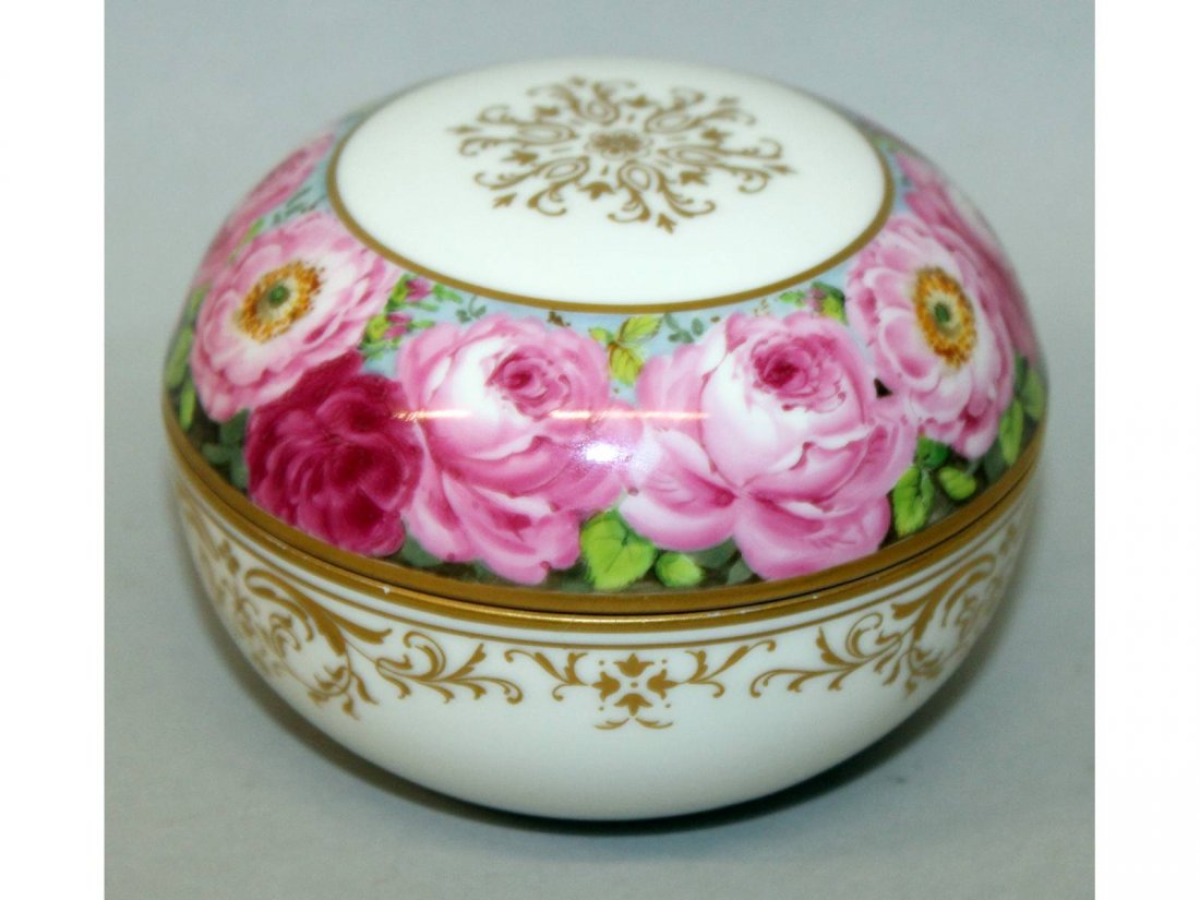 A Meissen circular box and cover, 3.5ins diameter, the: A Meissen circular box and cover, 3.5ins diameter, the lid painted with a band of roses. Cross swords mark in blue.