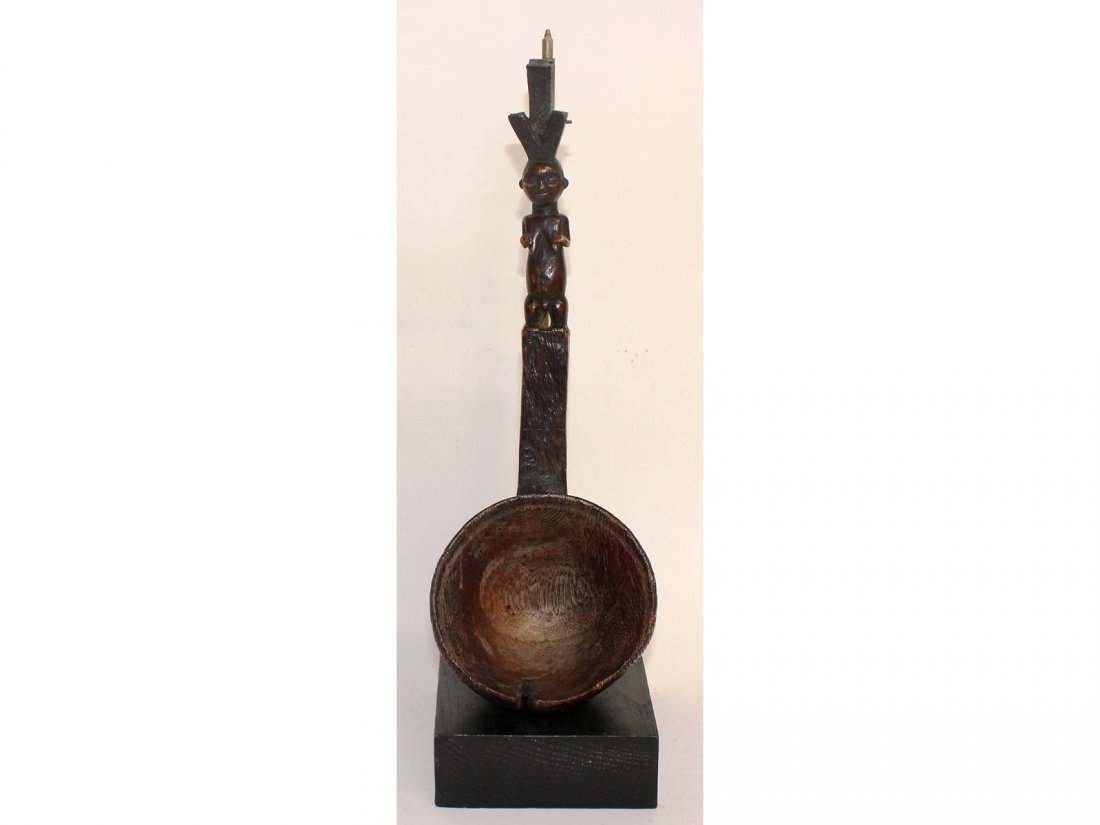 A good early carved wood tribal spoon, with female: A good early carved wood tribal spoon, with female handle. 14ins long.