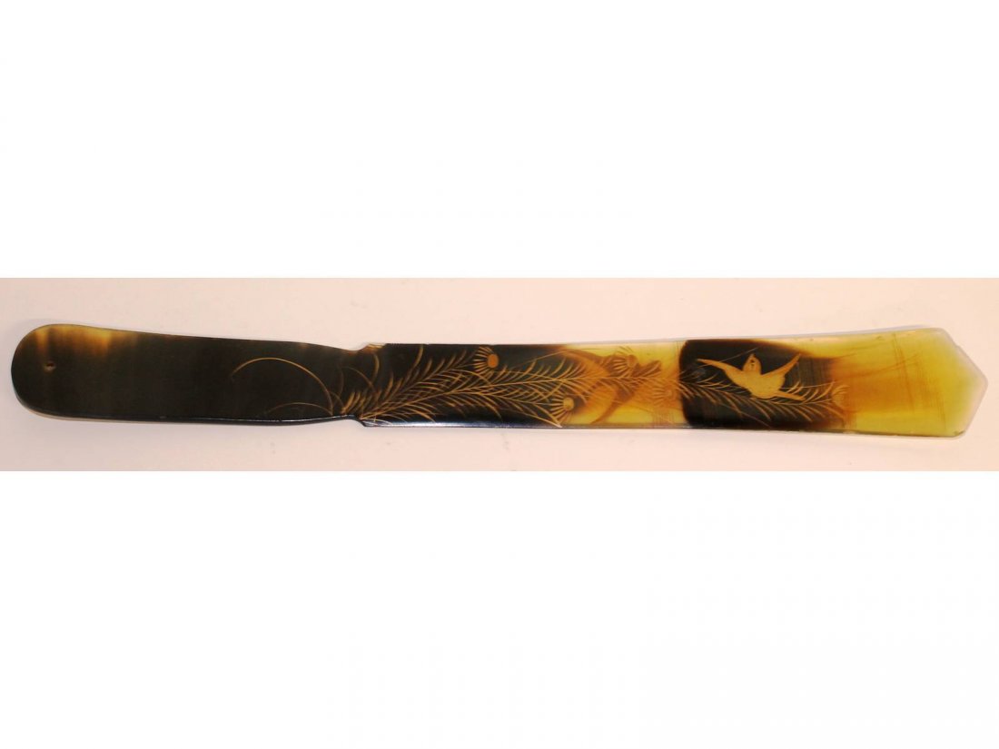 A tortoiseshell paper knife decorated with birds and: A tortoiseshell paper knife decorated with birds and flowers in relief. 13ins long.