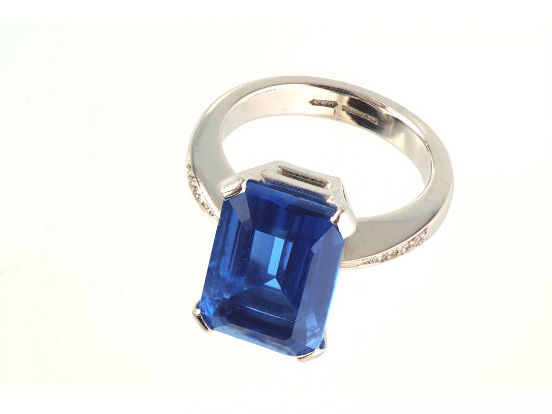 A large blue topaz ring, 5.5cts, with diamond: A large blue topaz ring, 5.5cts, with diamond shoulders, set in 18ct white gold.