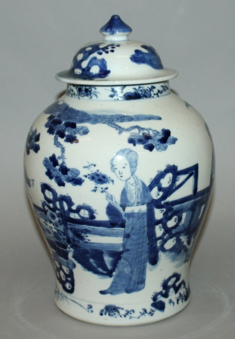 A 19TH CENTURY CHINESE BLUE & WHITE PORCELAIN VASE &: A 19TH CENTURY CHINESE BLUE & WHITE PORCELAIN VASE & COVER, the sides painted with a scene of ladies and children in a fenced garden setting, the base with a four-character Kangxi mark, 13in high over
