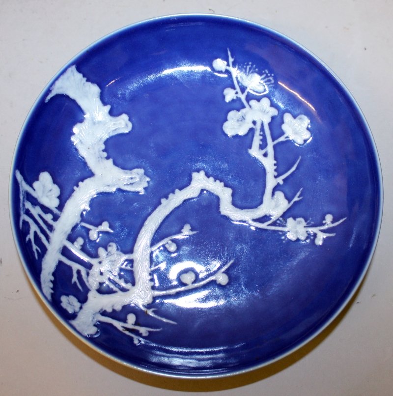 A WHITE SLIP DECORATED BLUE-GROUND PORCELAIN SAUCER (1 of 3)