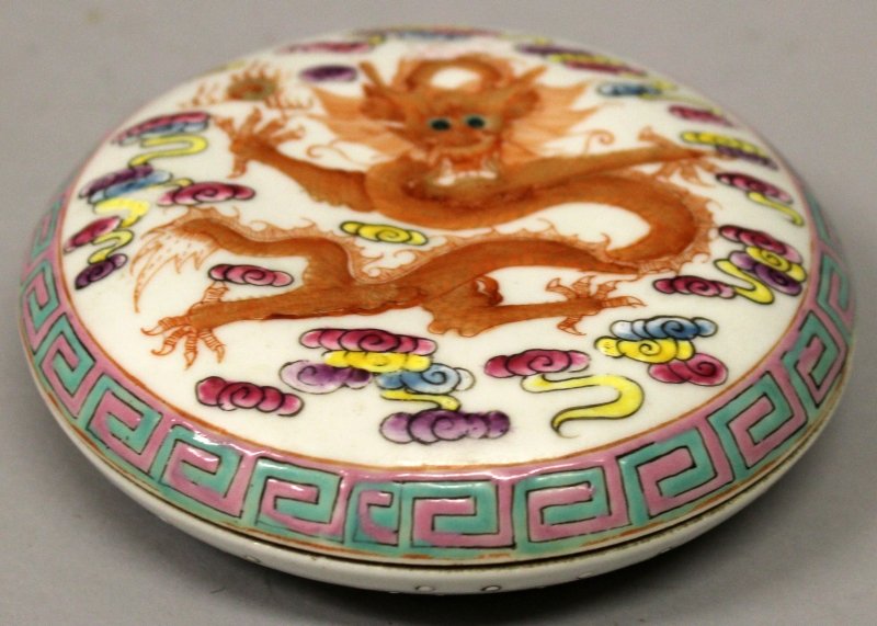 A SHALLOW CHINESE FAMILLE ROSE PORCELAIN BOX & COVER,: A SHALLOW CHINESE FAMILLE ROSE PORCELAIN BOX & COVER, the cover decorated with a dragon amidst cloud scrolls, the base with a six-character Daoguang mark, 4.6in diameter.