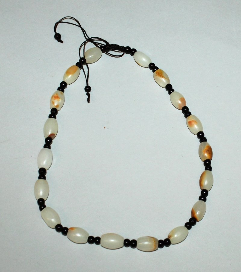 A CHINESE PALE CELADON JADE-LIKE NECKLACE, the oval (1 of 3)