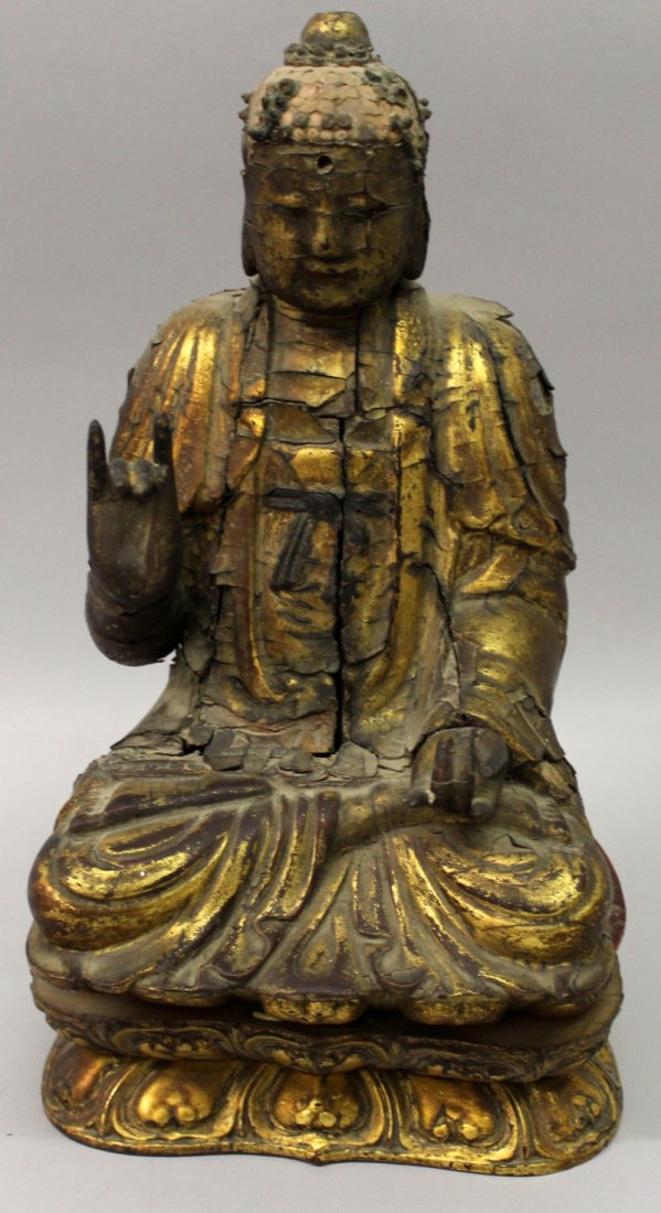 A JAPANESE EDO PERIOD GOLD LACQUERED WOOD FIGURE OF: A JAPANESE EDO PERIOD GOLD LACQUERED WOOD FIGURE OF BUDDHA, seated in meditation, the reverse with a removable back panel revealing an interior containing a prayer book and other items, 10.7in high.