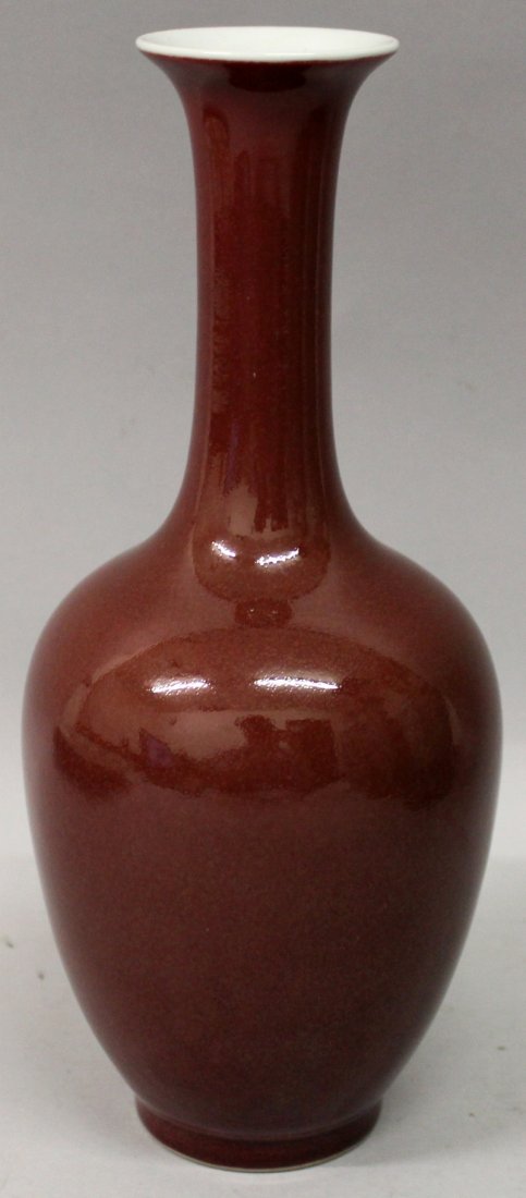 A CHINESE SANG-DE-BOEUF PORCELAIN BOTTLE VASE, applied (1 of 6)