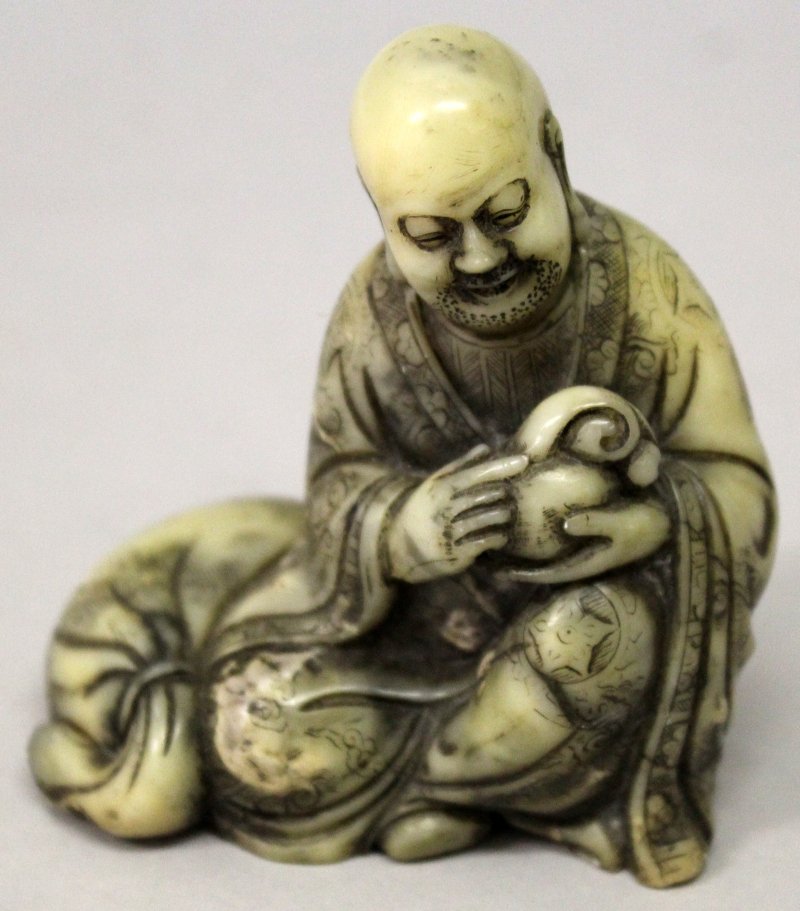 A CHINESE SOAPSTONE FIGURE OF A SEATED LOHAN, his robes (1 of 6)