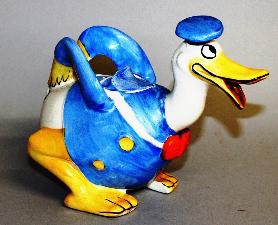 A WADE HEATH POTTERY TEAPOT, in the form of Donald: A WADE HEATH POTTERY TEAPOT, in the form of Donald Duck. 6.5ins long.